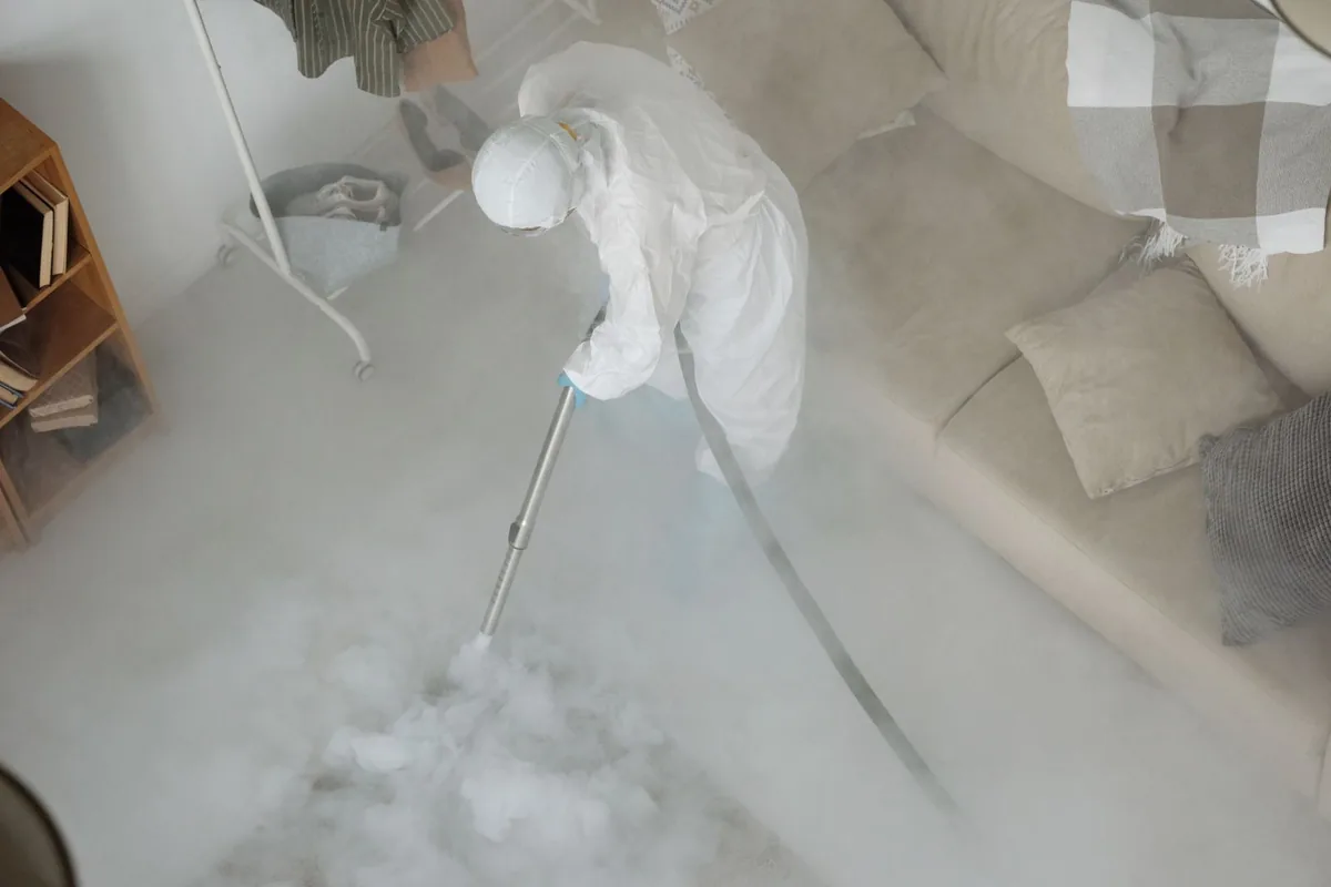 Biohazard cleanup technician in protective equipment, Howard City, MI